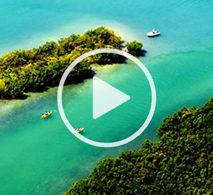 Aerial view of two kayakers and boat in canal